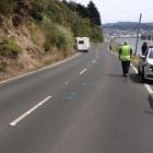 Police at the scene after tourist Wei Zhang’s campervan clipped the bicycle being ridden by...