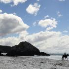 Cheryl Mangan (left) and Eli Cumming ride past Keyhole Rock at Aramoana yesterday, as the Dunedin...