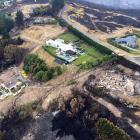 Surrounded by devastation, a helicopter fighting the Port Hills fire in Christchurch this week...
