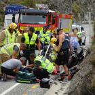 AJ Hackett Bungy staff help paramedics and fire volunteers after Sunday's crash. PHOTO: GUY...