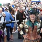 Dunedin Steampunk Society member James Bryan points a Steampunk-inspired camera lamp at fellow...