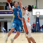 Otago’s Josh Aitcheson lines up to shoot over the top of Southland Sharks defender Derone Raukawa...