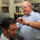 Lower Thames St mainstay Ali Brosnan cuts Ian Moore’s hair yesterday  afternoon. Mr Brosnan has...