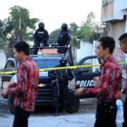 Policemen keep watch on the perimeter of a scene where a leader of the Beltran Leyva cartel was...