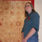 North Otago Museum curator Chloe Searle stands in front of a Red Cross quilt made by Ardgowan...
