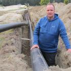 IceInLine chairman Murray Miller checks the trench for the heat exchange pipe installed this week...