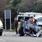 Members of the public assist after a truck and van crashed on the Southern Motorway yesterday....