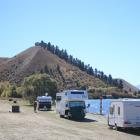 Caravans and camping vehicles parked on the shore of Lake Dunstan at Lowburn, near Cromwell. ...