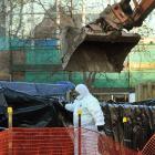 Workers in protective suits remove asbestos from the Great King St site where the University of...