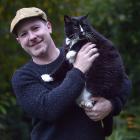 Jesse Bering holds his cat Tommy, who has lived with him in the United States, the United Kingdom...