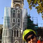 Adgraphix sales consultant Jono Gallacher in front of the clocktower after it was covered by a...