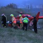 A 34-year-old Oamaru woman is carried to a rescue helicopter after crashing her car while fleeing...