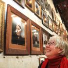 North Otago Early Settlers Association president Helen Stead inspects copies of portraits of...