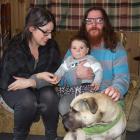 Liz Boyle and Joel Rowlands with their son, Rhythm, and dog Bossco at their rented home at...