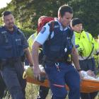 Emergency services carry a man in a Stokes basket from the Frasers Gully track yesterday, after...
