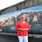 Diane Court at the new mural opposite Mosgiel RSA yesterday. Photos: Peter McIntosh.