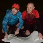 Supporter Bruce Adams (left) and long-distance runner Glenn Sutton study a map of Haast in Dunedin last night. Photo: Linda Robertson.