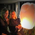 Cromwell and Districts Promotion Groups community relationships manager Brigitte Tait (right) and Carolyn Murray, of Scott Base Winery, try out one of the lanterns to be released at the Light Up Winter event in Cromwell. The new event will be held on Augu