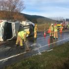 The driver of this truck suffered moderate injuries when it rolled this morning. Photo: Creaig...