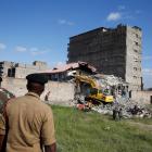 Security personnel look at the scene after a building collapsed in a residential area of Nairobi. Photo: Reuters