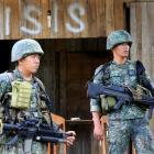 Soldiers stand guard along the main street of Mapandi village as government troops continue their assault on insurgents from the Maute group. Photo: Reuters