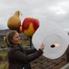 Light Up Winter organiser Brigitte Tait braves the wind to release one of the lanterns that will...