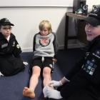 Angelique Price (12), of Queenstown, treats the fake foot wound of Noah Miller (8), of Queenstown...