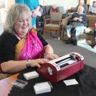 "That Blind Woman'' Julie Woods types a Holmdene resident's name in Braille as part of a new...