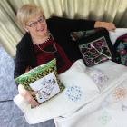 Creative Arts Centre president Mearle Wilson shows off her specially embroidered quilt which will...