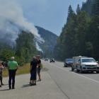 Tourists from Denmark stop to photograph one of several wildfires burning near Little Fort,...