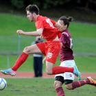 Caversham striker Tore Waechter (left) gets the jump on Dunedin Technical's Logan Mamanu during...