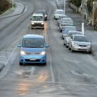 Vehicles travel slowly in Warrender St in North Dunedin yesterday.