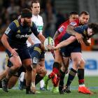 Richard Buckman (R) of the offloads the ball to team mate Liam Coltman of the Highlanders. Photo:...