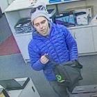 The alleged offender with the bag in which stolen items were placed. Photo: NZ Police.