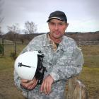 Alexandra man Robert Andrews holds the helmet of his pilot brother who died in a helicopter crash...