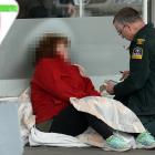 A St John staff member talks to a woman who suffered a medical event in South Dunedin yesterday...