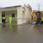 Weston Volunteer Fire Brigade members pump  out  the car park next to the old Weston Memorial...