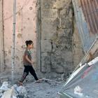 A girl walks on debris in a rebel-held part of the southern city of Deraa, Syria. Photo: Reuters