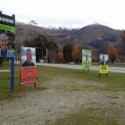 Billboards advertise candidates in the Wanaka by-election. Photo: Tim Miller.