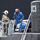 Police technicians inspect the wreck of the submarine in Copenhagen Harbour. Photo Reuters

