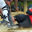 Jake Burtenshaw (Dodgers) slides into home base before the tag of Saints catcher Sean Bennett at Ellis Park on Saturday. Photo by Peter McIntosh.