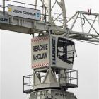 A crane driver climbs to his lofty workplace with its new name displayed on the back of the cab....