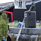 Police technicians investigate the rescued private submarine "UC3 Nautilus" in Copenhagen. Photo:...