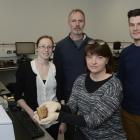Canterbury Museum curator human history Dr Jill Haley holds a dog biscuit recovered from the...