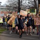 Hundreds marched across the campus in opposition to a plan cut staff and papers at the School of...