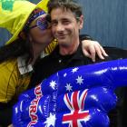 Kingston's Tori Keating, a staunch Wallabies supporter, kisses her husband Malcolm Mackay, a...