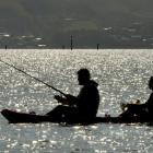 Salmon fishers try their luck on Otago Harbour. Photo: Stephen Jaquiery