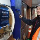 Williams Signs &amp; Graphix signwriter Casey Munro paints near the Speight’s Brewery public...