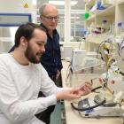 Dr Kiel Hards (foreground), watched by Prof Greg Cook, uses a chemostat in a laboratory at the...