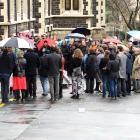 About 100 people gather at the University clock tower to protest job cuts. Photo: Stephen Jaquiery